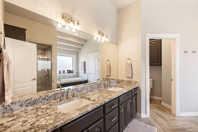 bathroom featuring a tile shower, baseboards, a garden tub, and a sink