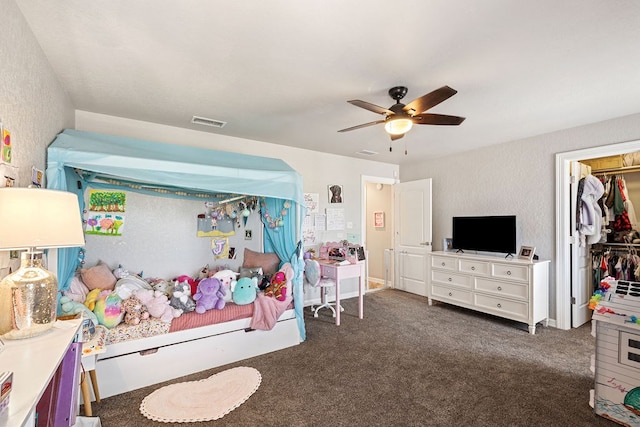 carpeted bedroom featuring visible vents, a closet, and ceiling fan