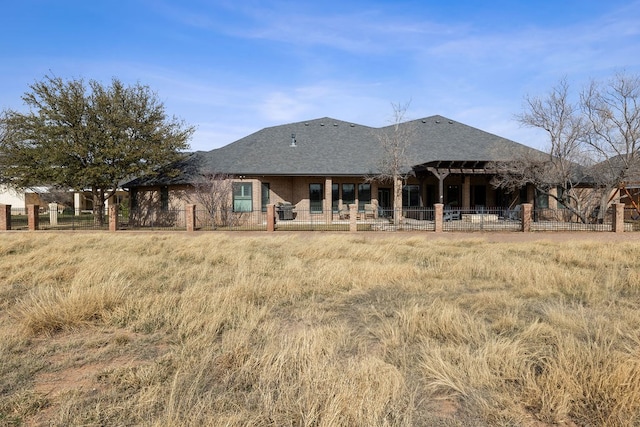 rear view of house featuring fence