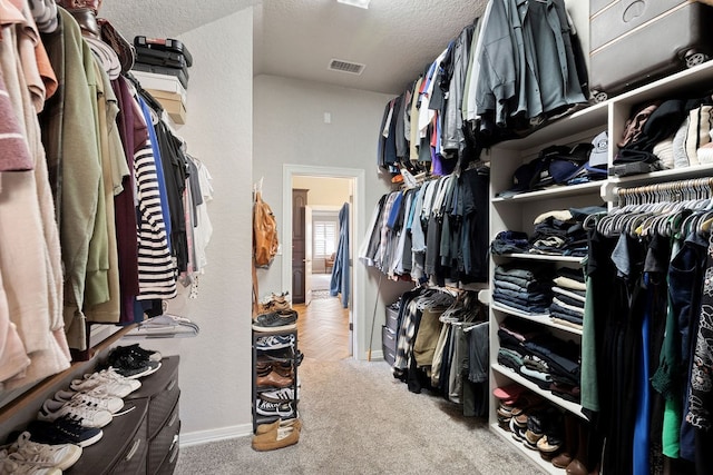 walk in closet with visible vents and carpet floors