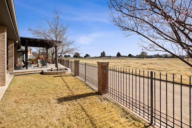 view of yard with a rural view, a patio, a fenced backyard, and a pergola