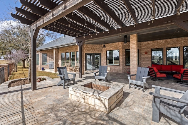 view of patio / terrace with grilling area, a pergola, and an outdoor living space with a fire pit