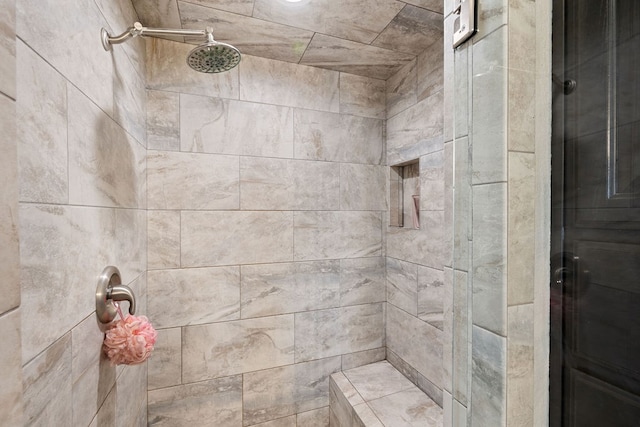 bathroom with a tile shower