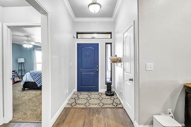 foyer entrance featuring crown molding and wood-type flooring