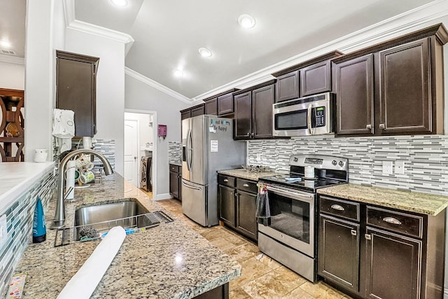 kitchen featuring stainless steel appliances, tasteful backsplash, sink, and dark brown cabinetry