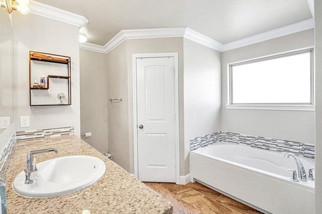 bathroom with vanity, ornamental molding, and a tub to relax in