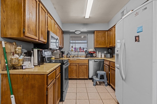 kitchen featuring stainless steel appliances and sink