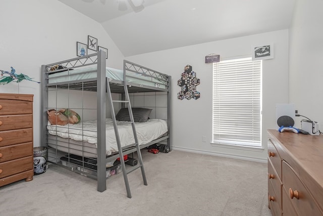 bedroom featuring multiple windows, lofted ceiling, light colored carpet, and ceiling fan