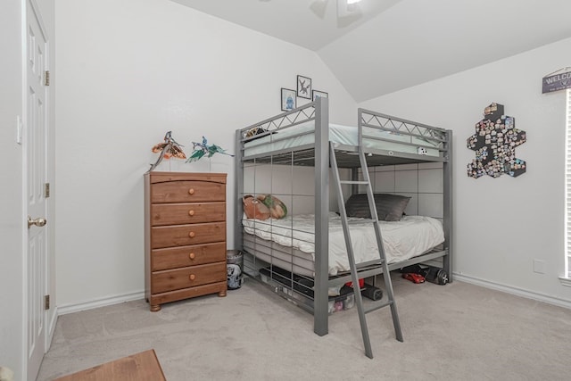 carpeted bedroom featuring vaulted ceiling and ceiling fan