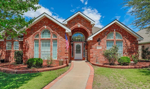 view of property featuring a front lawn