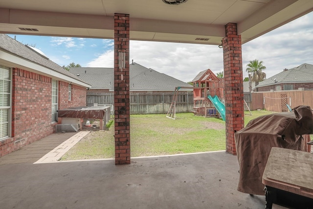 view of patio / terrace featuring area for grilling and a playground