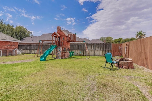 view of yard featuring a playground and an outdoor fire pit