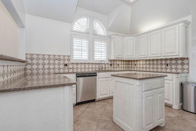 kitchen featuring a kitchen island, dishwasher, sink, white cabinets, and light stone countertops