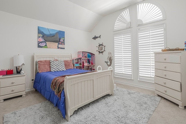 carpeted bedroom featuring vaulted ceiling