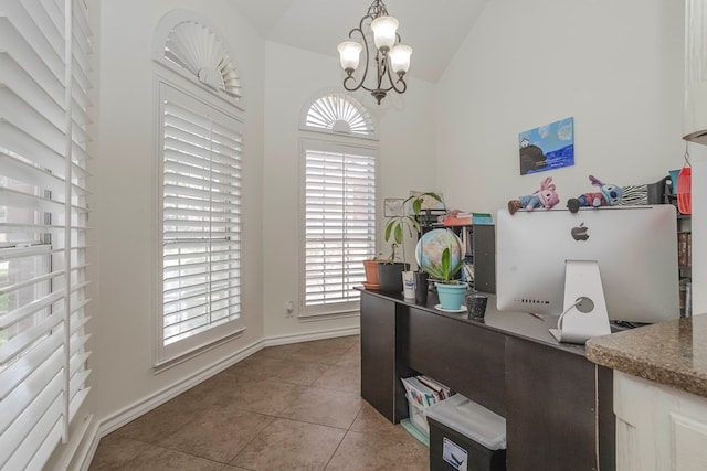 tiled home office with lofted ceiling and a notable chandelier