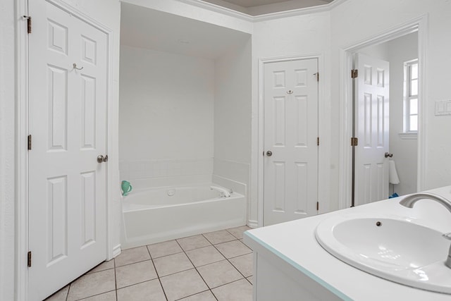 bathroom featuring tile patterned flooring, vanity, and a washtub