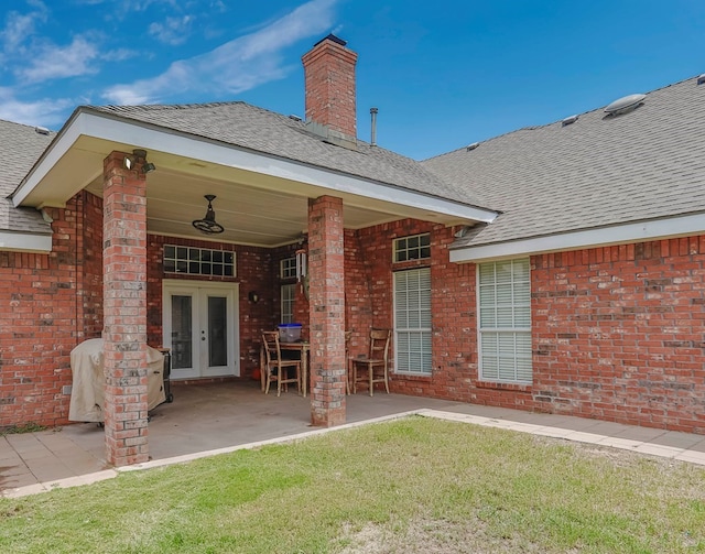 back of property featuring a yard, a patio area, and french doors