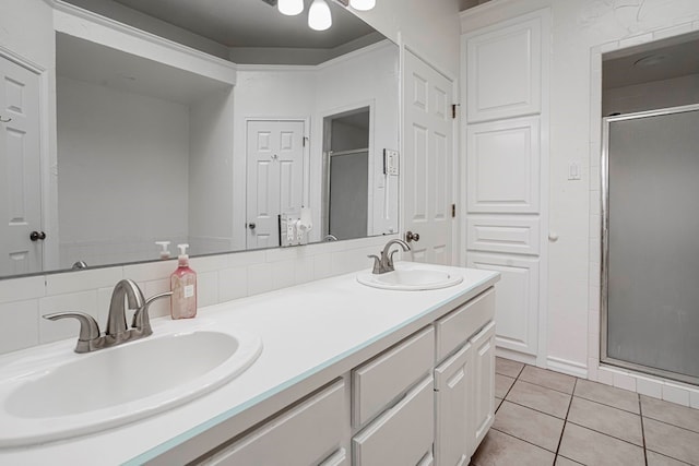 bathroom with tile patterned flooring, vanity, and a shower with door