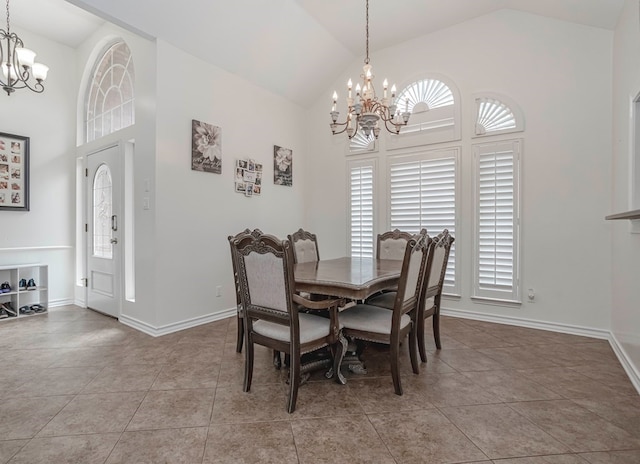 tiled dining area with an inviting chandelier and high vaulted ceiling