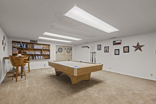 rec room with a textured ceiling, pool table, and light carpet