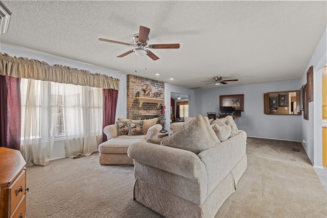 carpeted living room with ceiling fan, a fireplace, and a textured ceiling