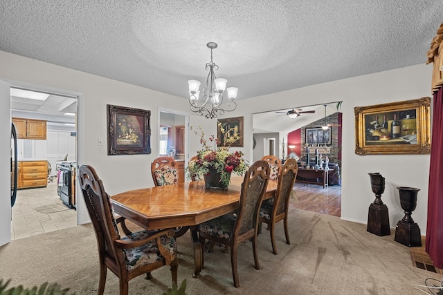 dining space with a textured ceiling, light carpet, and ceiling fan with notable chandelier