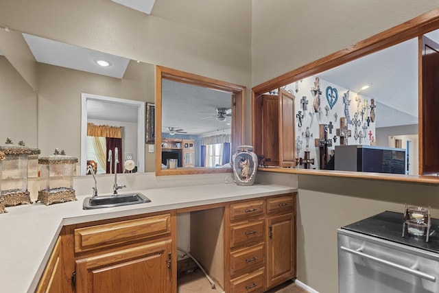 kitchen featuring kitchen peninsula, a textured ceiling, ceiling fan, and sink