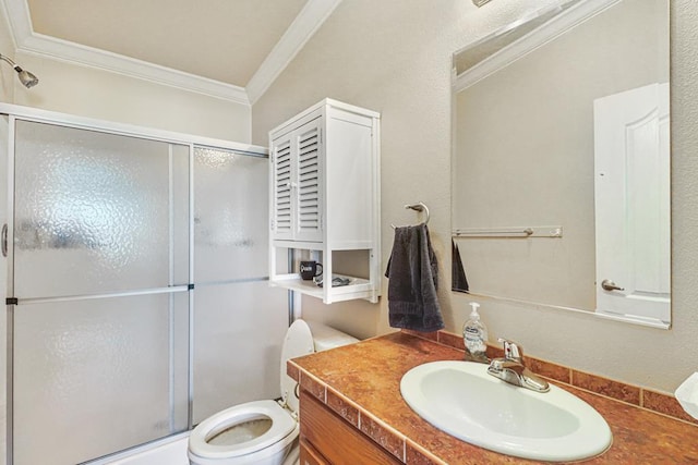 bathroom featuring vanity, a shower with door, ornamental molding, and toilet