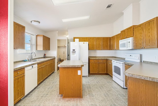 kitchen with sink, white appliances, vaulted ceiling, and a center island