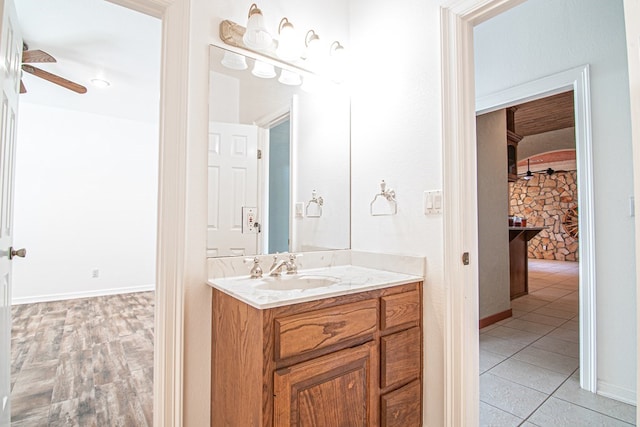 bathroom with tile patterned floors, vanity, and ceiling fan