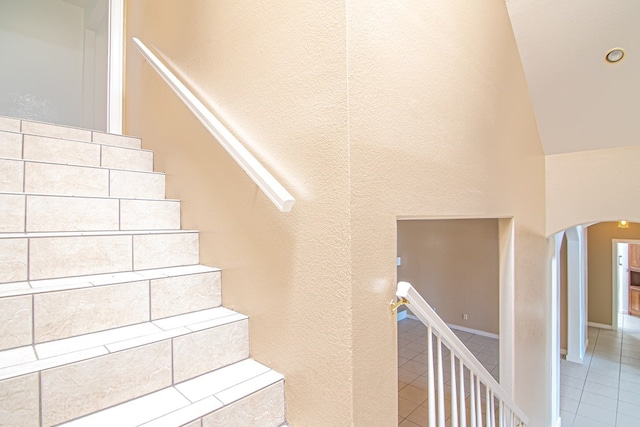 stairway featuring tile patterned flooring