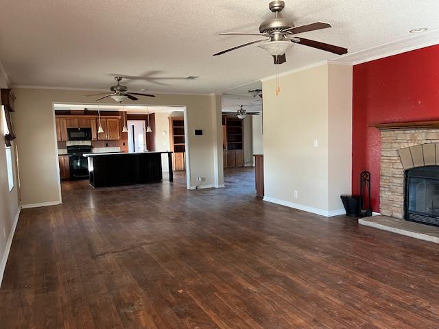 unfurnished living room with crown molding, a fireplace, and dark hardwood / wood-style flooring