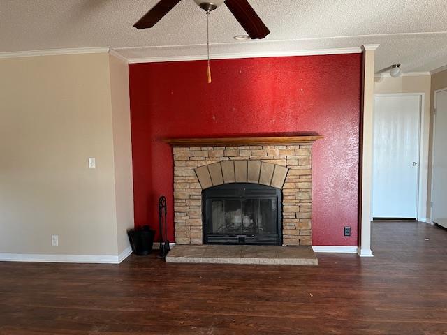 details featuring hardwood / wood-style flooring, ornamental molding, a stone fireplace, and a textured ceiling