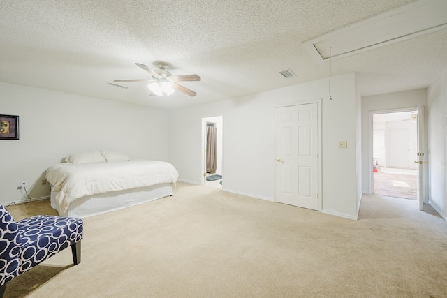 carpeted bedroom featuring ceiling fan and a textured ceiling