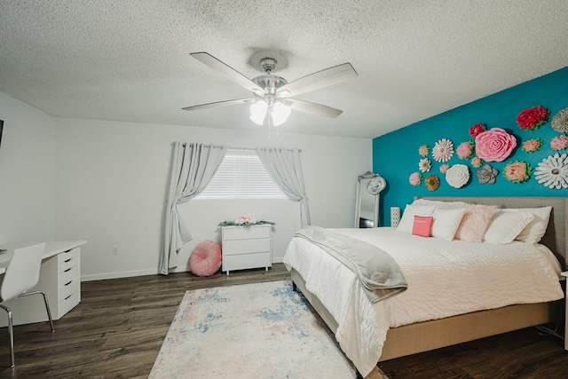 bedroom with a textured ceiling, ceiling fan, and dark hardwood / wood-style floors