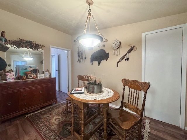 dining room with dark hardwood / wood-style flooring