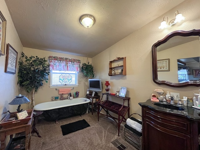 bedroom featuring a textured ceiling, carpet, and sink