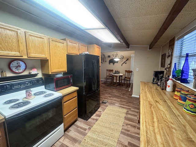 kitchen with black refrigerator, light wood-type flooring, light brown cabinets, and electric range oven