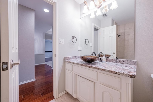 bathroom with hardwood / wood-style flooring and vanity