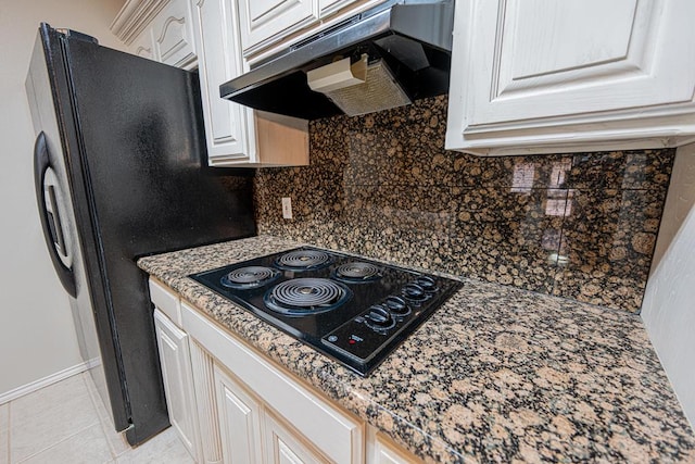 kitchen featuring white cabinetry, backsplash, light tile patterned floors, and black appliances