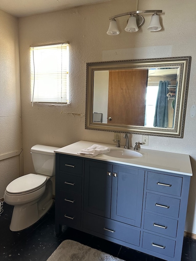 bathroom with tile patterned floors, vanity, and toilet