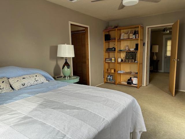 bedroom featuring ceiling fan, light colored carpet, and a closet