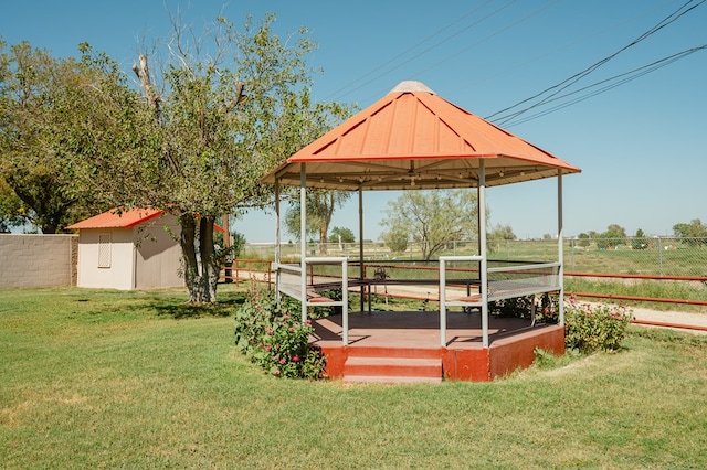 view of yard with a gazebo, a rural view, and a storage shed