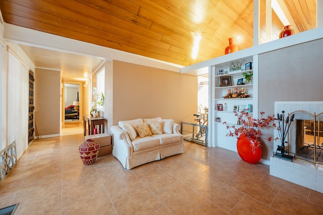 tiled living room featuring built in shelves, a healthy amount of sunlight, wood ceiling, and a fireplace