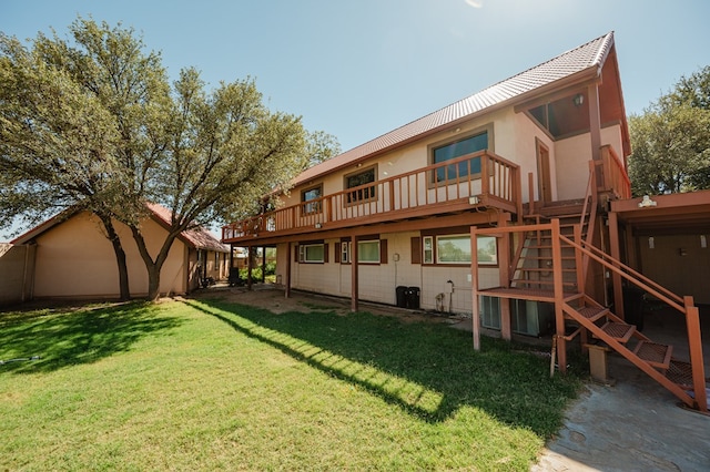 back of property featuring a yard and a deck