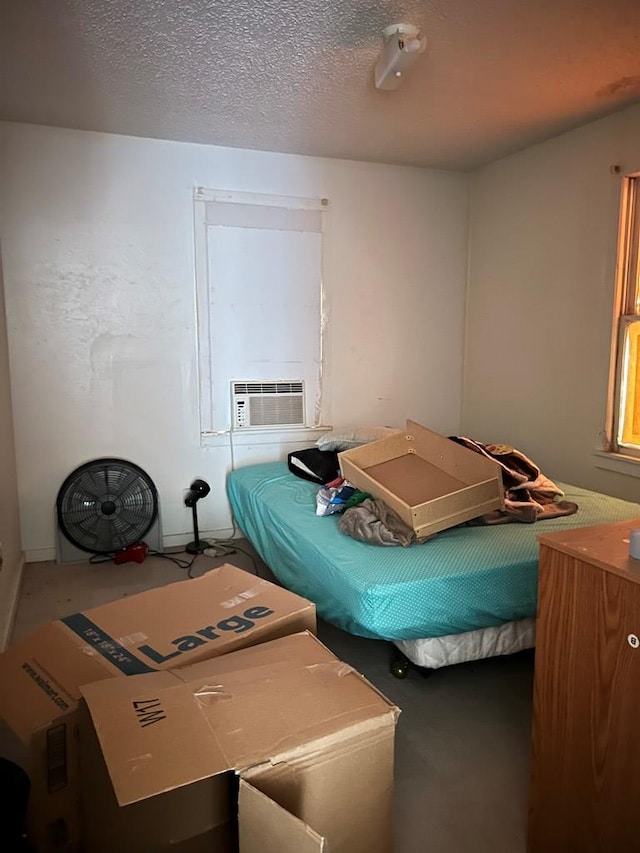 bedroom with cooling unit and a textured ceiling