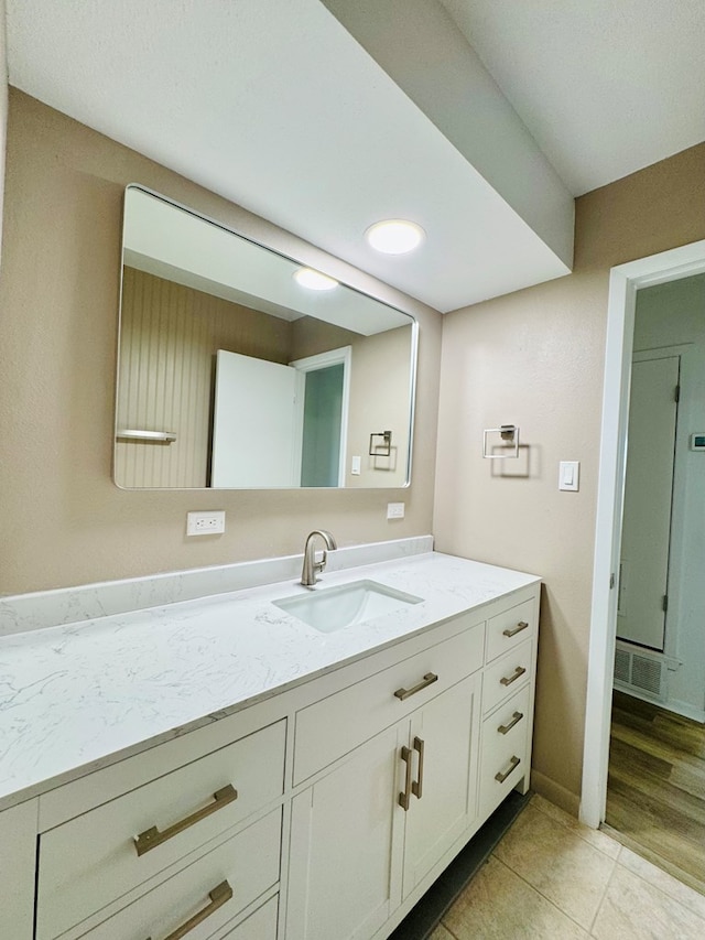 bathroom with vanity, baseboards, tile patterned flooring, and visible vents