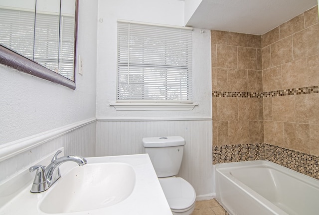 bathroom with tile patterned floors, a textured ceiling, toilet, and sink