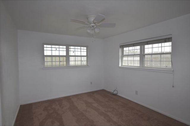 carpeted spare room with ceiling fan