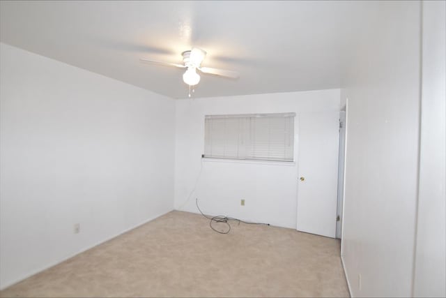 empty room with light colored carpet and ceiling fan